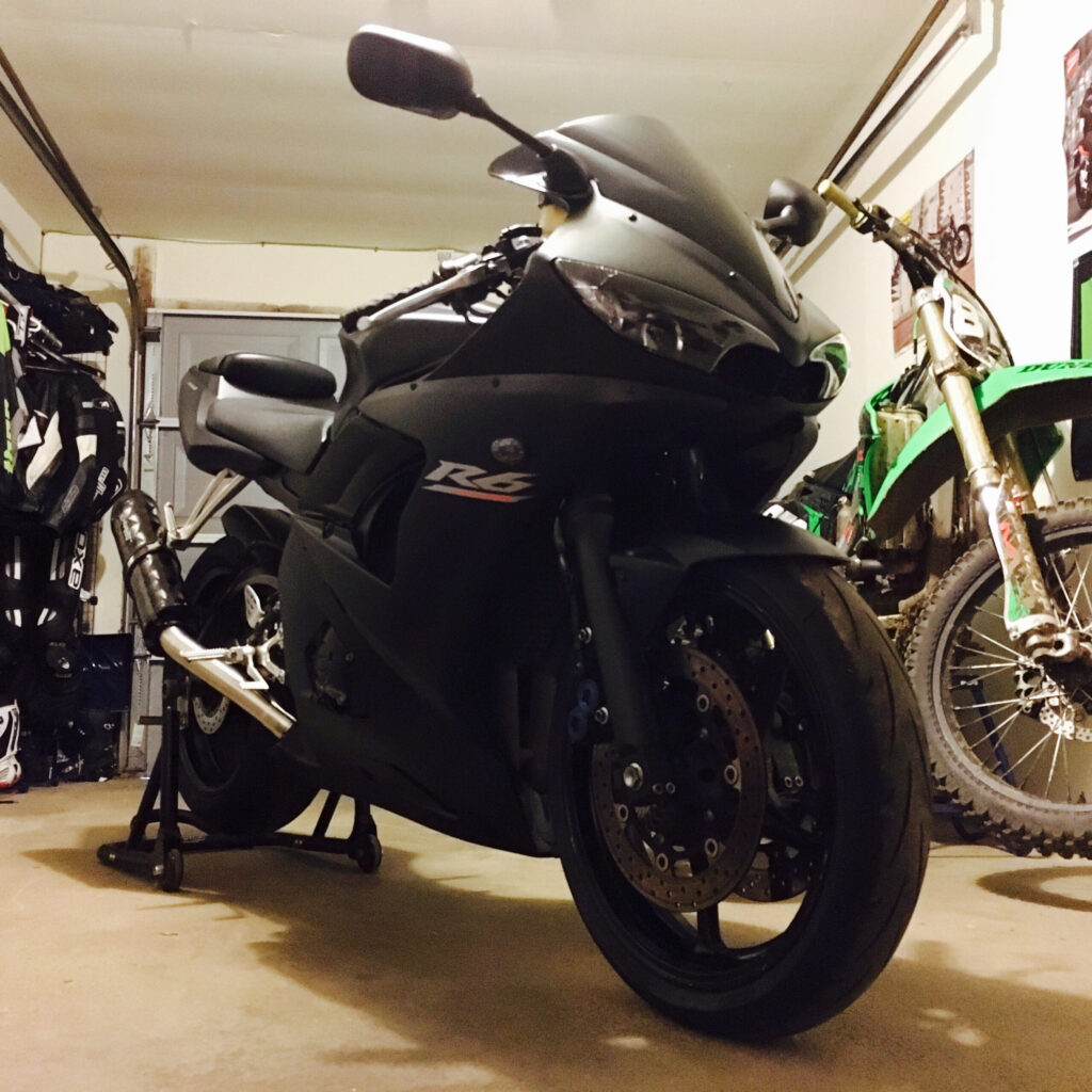A black sports motorcycle parked in a home garage.